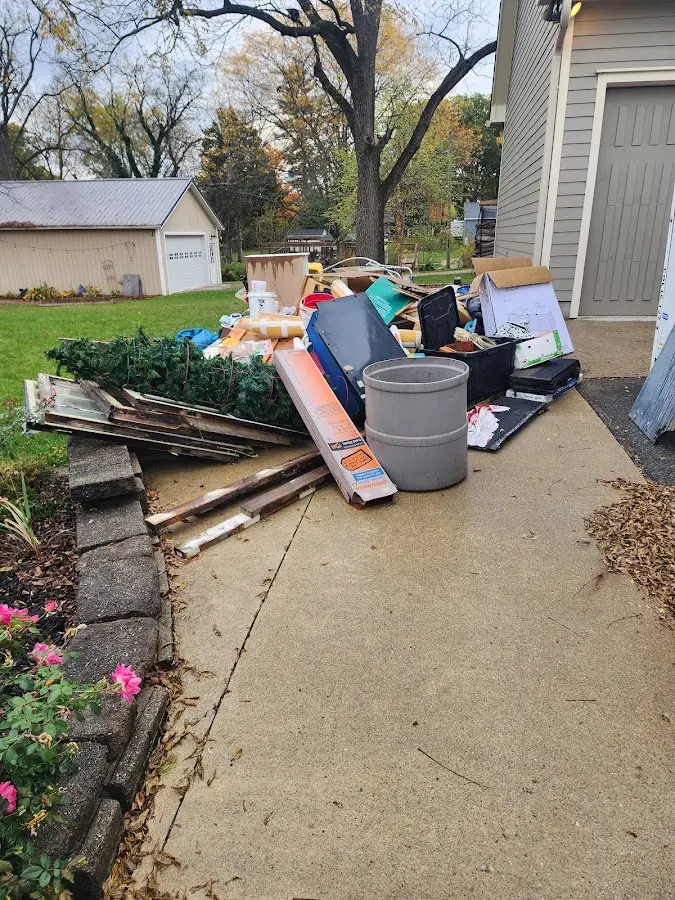 Dumpster being loaded with debris for Roofing Dumpster Rental in Holmes Beach